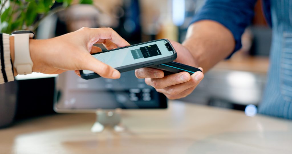 Customer paying cashier using phone