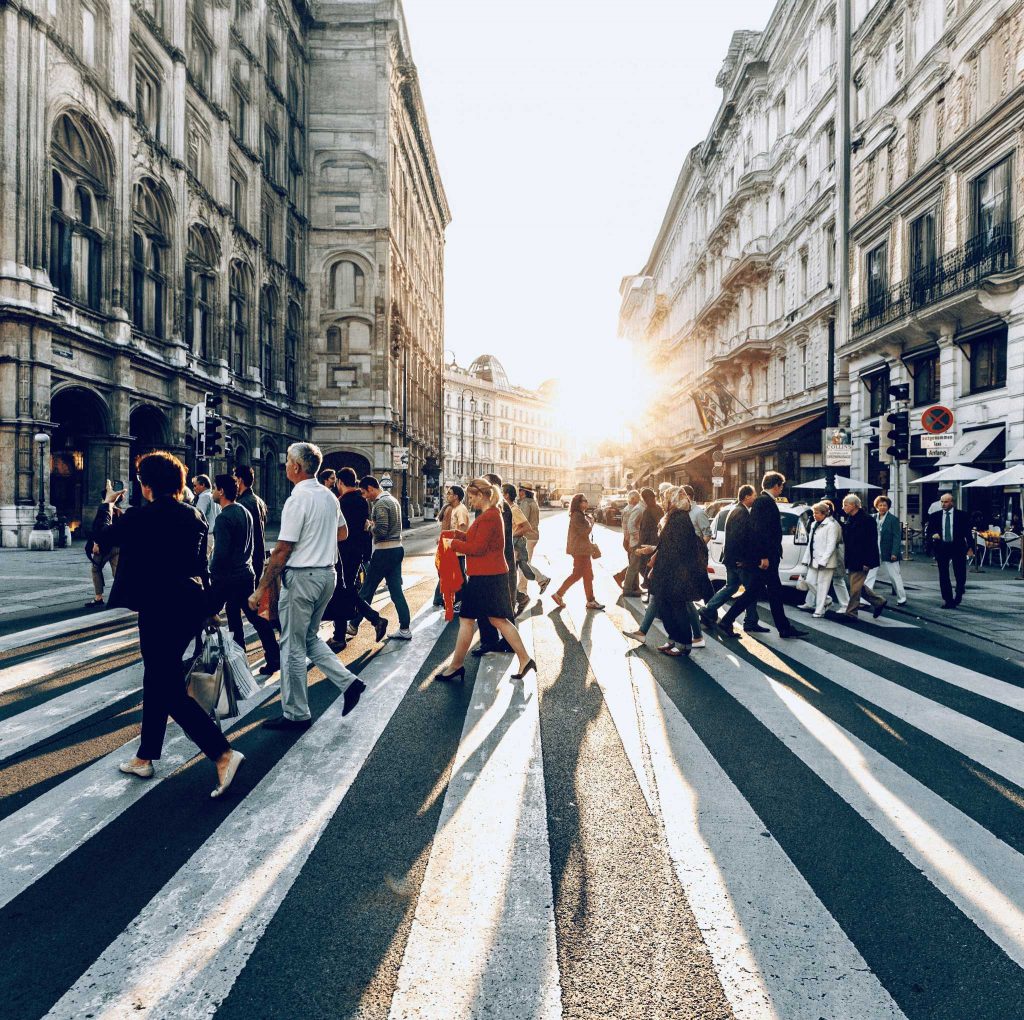 Image of people crossing a busy street in Europe