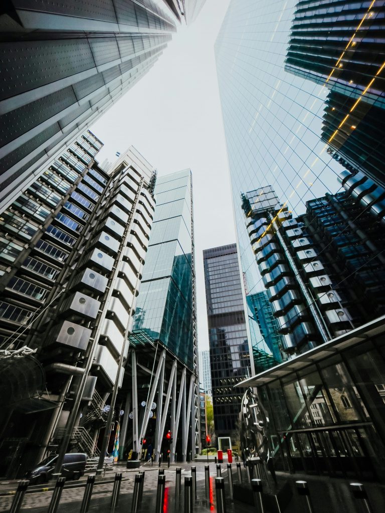 Looking up at big glass city skyscrapers